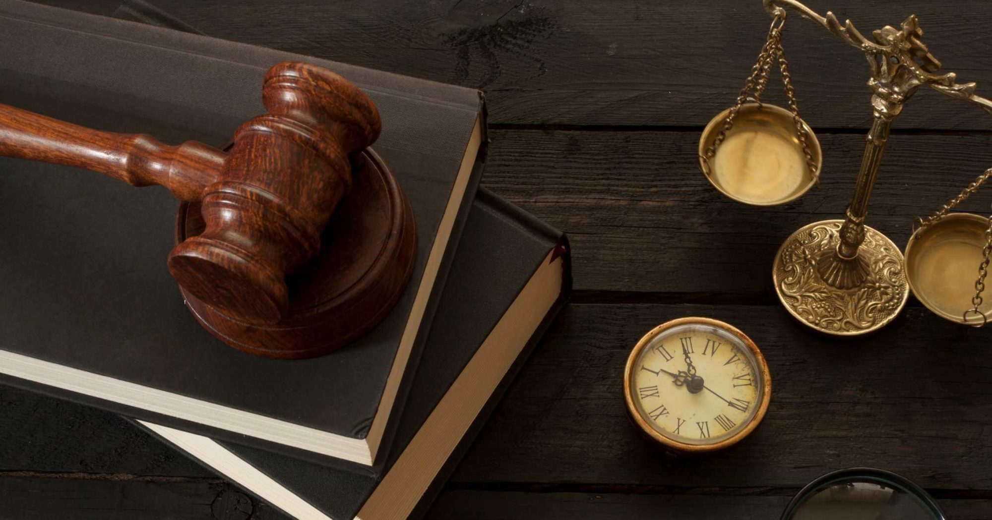 Gavel on law books with a compass on a wooden desk – Eleven Legal strata law services