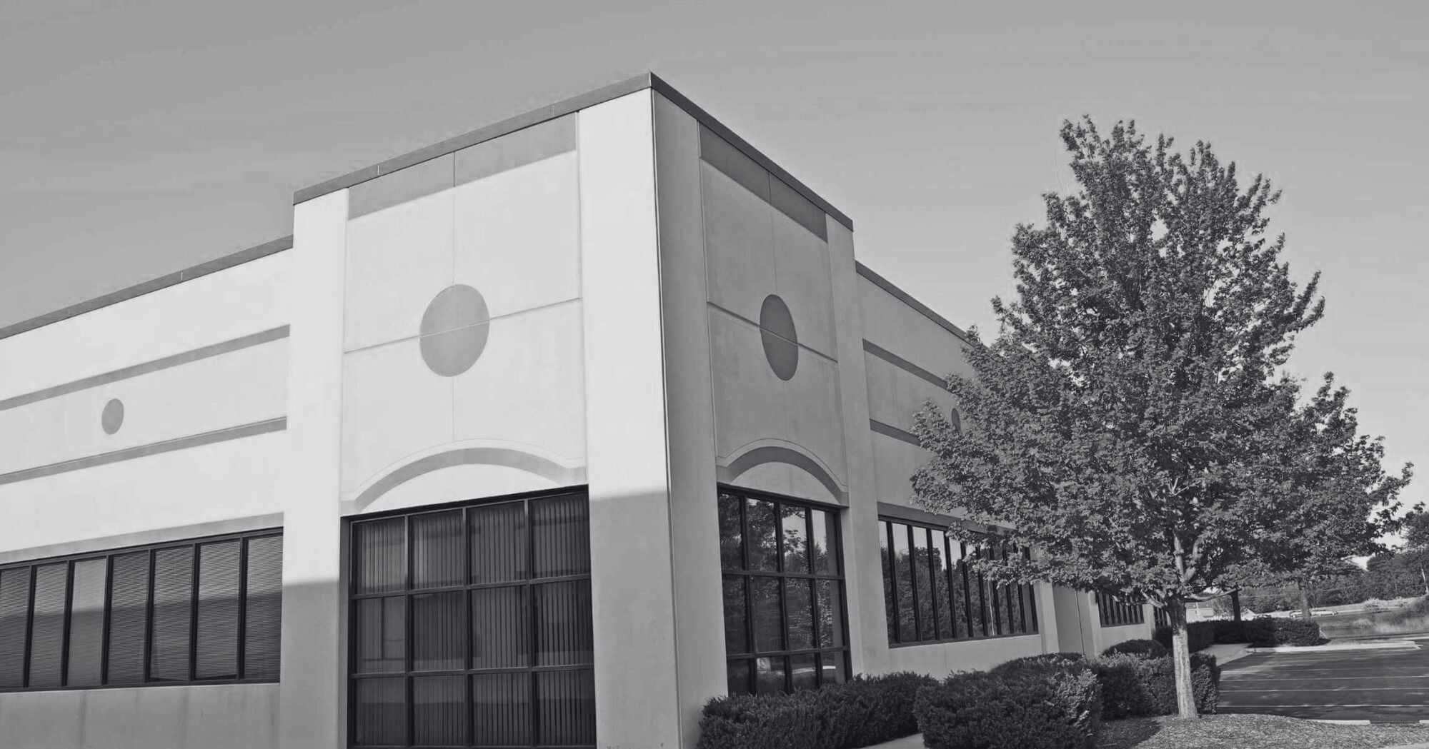 Modern commercial or retail building with clear skies – Eleven Legal